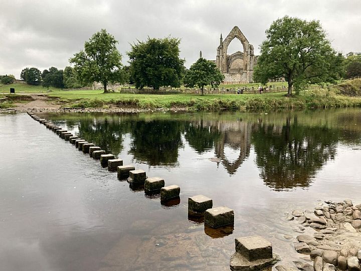 Bolton Abbey with river and stepping stones in the foreground